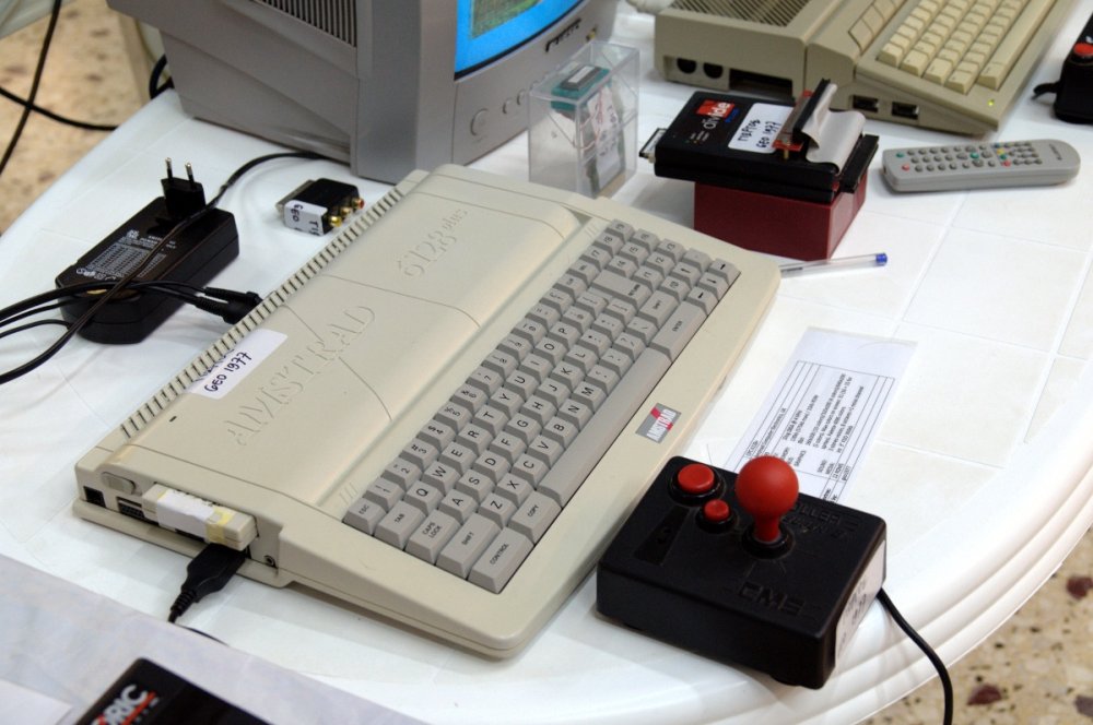 Amstrad CPC 6128 Plus with joystick and cartridge on an exhibition table
