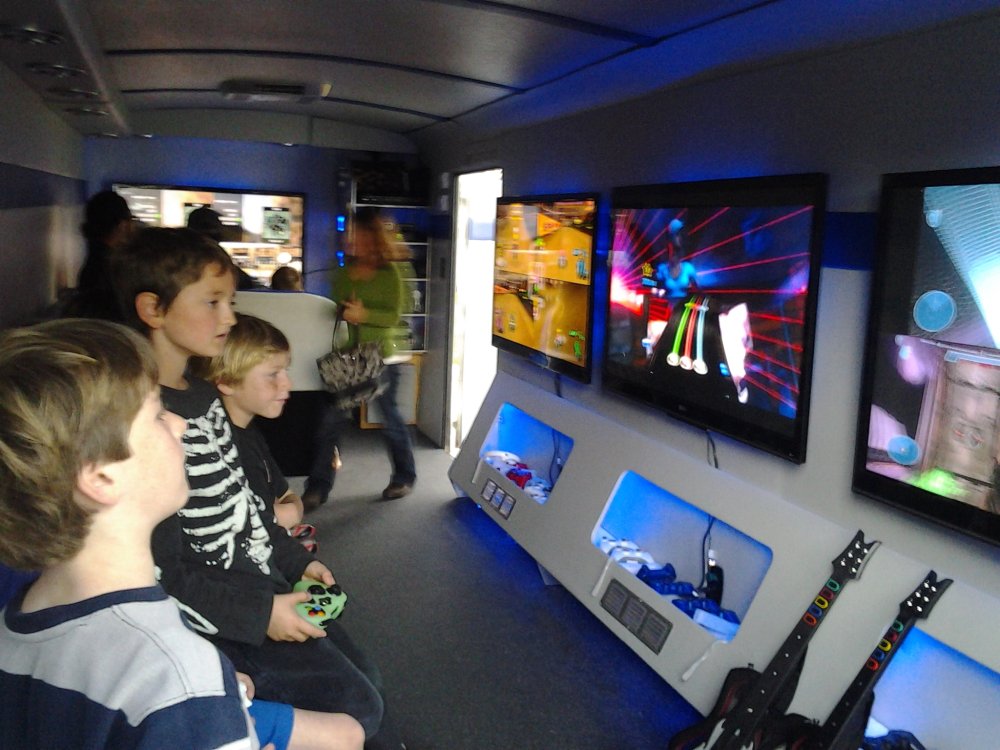 Children playing video games on multiple screens
