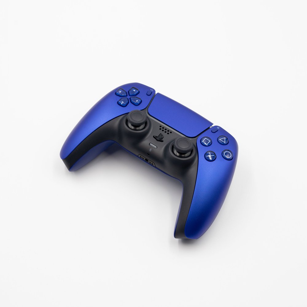Cobalt blue DualSense PlayStation controller on white background, illustrating the arrival of Roblox on PS5/PS4