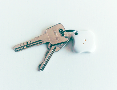 GPS tracker placed on a table and attached to keys